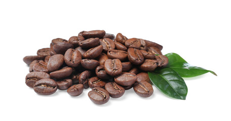 Pile of roasted coffee beans with fresh leaves on white background