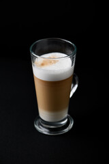 Coffee with milk on dark background. Close up. Copy space.	
