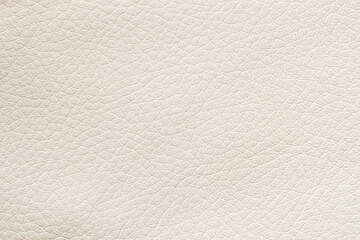 Texture of genuine leather, beige color, background, pattern. Manufacturing of leather accessory concept