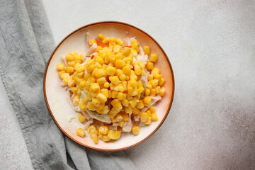 step-by-step preparation and ingredients for festive salad of smoked corn ham and potato chips close-up selective focus.