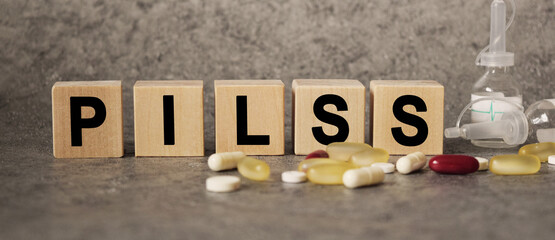 PILSS as a text with letters, corona virus pandemic with word cubes on a dark grey background with space for text.