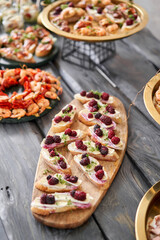 Delicious canapes with camembert and blackberries. Tasty buffet table. Summer party. Catering concept