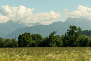 Obraz premium Oberriet, Switzerland, June 13, 2021 Green meadow in an alpine scenery on a sunny day