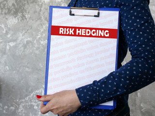Business concept meaning RISK HEDGING with sign on the piece of paper.