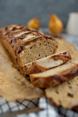 pear bread on dark grey background. wheat flour on a pear loaf cake