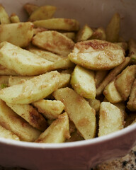 Slice apples coated with brown sugar in large bowl. 