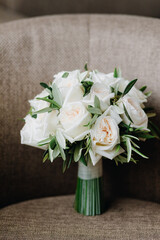 Wedding bouquet of delicate white roses on a gray background