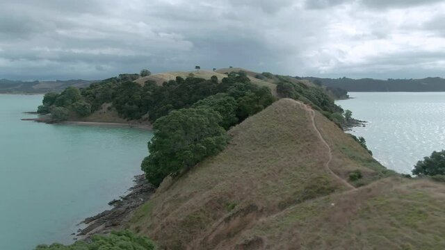 Aerial: Farmland and hiking trail at Duder Regional Park in the Hauraki Gulf. Auckland, New Zealand