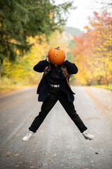person with a pumpkin on their head dancing 