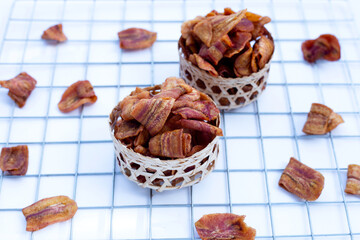 Banana slice chips on white background.