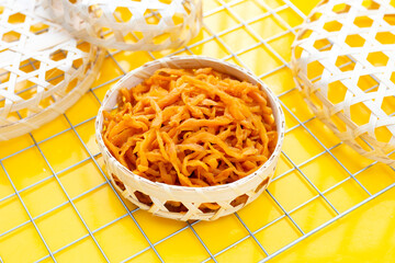 Pickle Turnip in bamboo basket on yellow background.