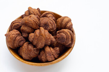 Mini chocolate croissant in wooden bowl on white background.