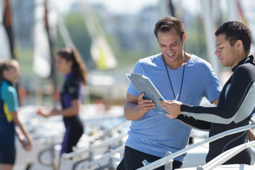 sailing trainer with young apprentice