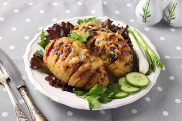 Baked potatoes stuffed with sausage and cheese on a white plate