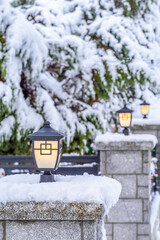 stone fence with lamps and snow