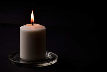 burning candle isolated with black background. Space for text.