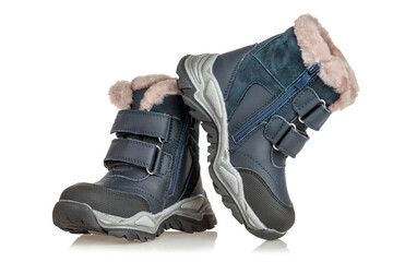 A pair of boots for winter snowy weather, insulated with fur, waterproof, shoes for children, isolated on a white background, close-up