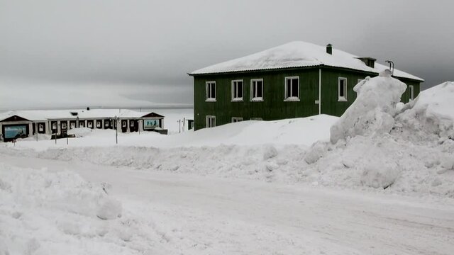 BARENTSBURG, SVALBARD 25 APRIL, 2013: Landscape and buildings in Russian Arctic mine village of Barentsburg on coast of Arctic Ocean on Svalbard. Coal mines.