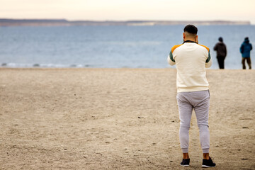 Tourist watches southern right whales at El Doradillo beach, near Puerto Madryn, Argentina
