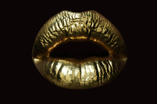 Gold lips, golden lipgloss on sexy lips, metallic mouth. Beauty woman makeup close up. Golden lip texture.