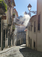 Porto historical city street in morning light with smoke.
