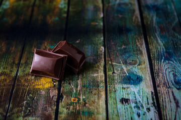 two chocolates with wooden base
