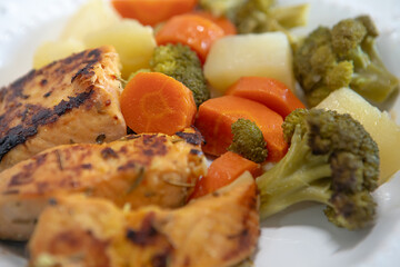 fish, and vegetables. macro photography of salmon, broccoli, carrots and potatoes