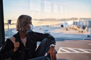 New normal and social distance concept. Young woman tourist wearing face mask during corona virus...