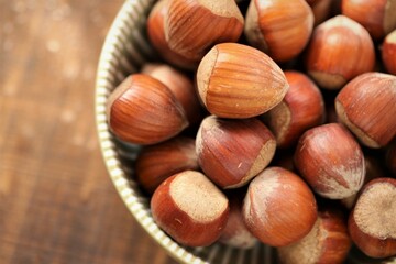ripe hazelnuts close-up in a round cup on a wooden table.Vegetable protein source. healthy snack. Healthy fats. Farmed organic hazelnuts