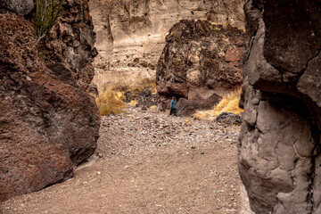 Woman Walks Through Tuff Canyon Wash