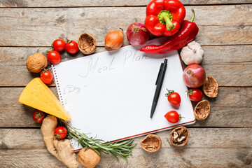 Healthy fresh products with meal plan on wooden background