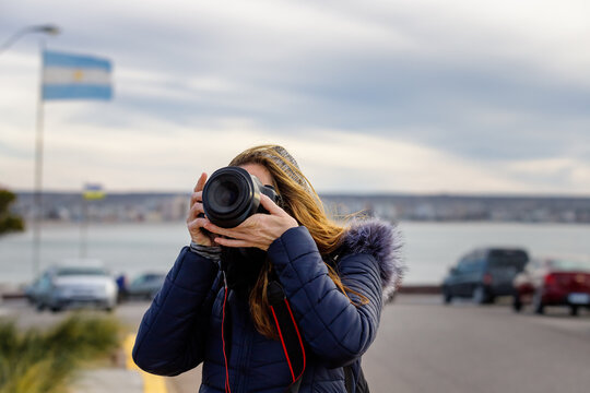 Tourist woman takes pictures in Puerto Madryn, Argentina