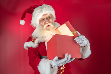 Emotional senior male model old man with a natural white beard in the role of Father Christmas