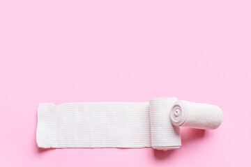 Elastic bandage rolls on pink background