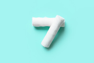 Medical gauze rolls on color background