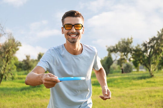 Young man playing frisbee in park