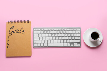 Notebook with empty to do list and computer keyboard with cup of coffee on color background. New year goals