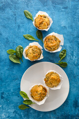 Composition with tasty spinach muffins on color background