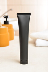 Black toothpaste with activated carbon on table in bathroom
