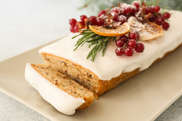 Plate with tasty Christmas bread on light background