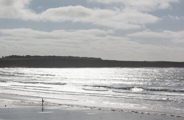 Lone fisherman on a beach on the Wild Atlantic Way selective focus