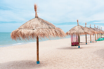 Parasols sunbed beach clouds turquoise sea.Panorama colorful umbrellas white sandy