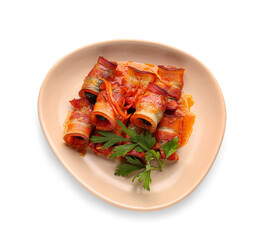 Plate with prunes in crispy bacon and parsley on white background