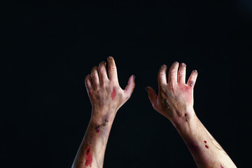 Hands of zombie on dark background