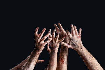 Hands of zombies on dark background