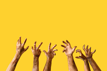 Hands of zombies on color background