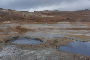Fototapeta na wymiar Myvatn Region, Iceland: Namafjall (also known as Hverir) is a high-temperature geothermal area with boiling mud pots and steaming fumaroles.