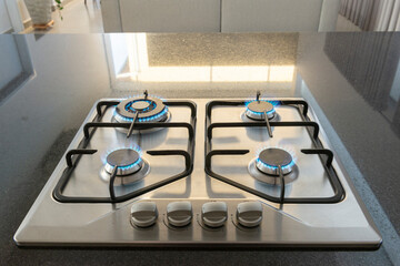 Modern hob gas stove made of stainless steel using natural gas or propane for cooking products on...