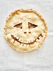 Homemade meat Witch pie for Halloween party. Scary face on the cake. Homemade baked goods