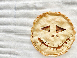 Homemade meat Witch pie for Halloween party. Scary face on the cake. Homemade baked goods